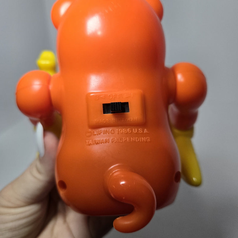 Animated Orange Monkey Toy with Yellow Hat Patent Pending