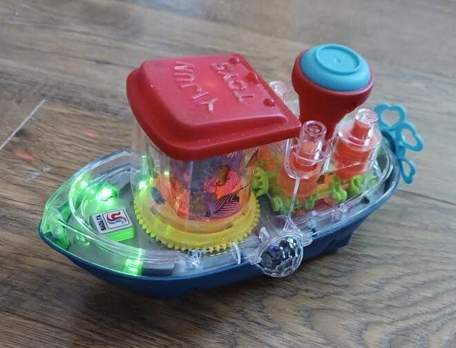 Plastic Bump N Go Tugboat Toy with Lights, Movement, and Music